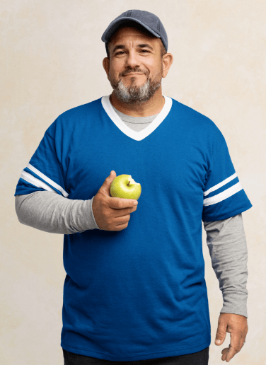 Man with NASH with liver scarring holding an apple and smiling